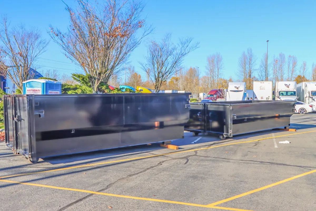 Professional dumpster rental service with roll-off container on residential driveway in Reston